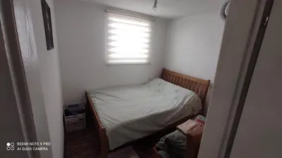 a small bedroom with a bed and a window at Vlašić vikendica BHL in Šišava