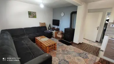 a living room with a couch and a stove at Vlašić vikendica BHL in Šišava