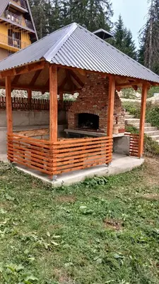 a wooden gazebo with a fireplace in a yard at Vlašić vikendica BHL in Šišava