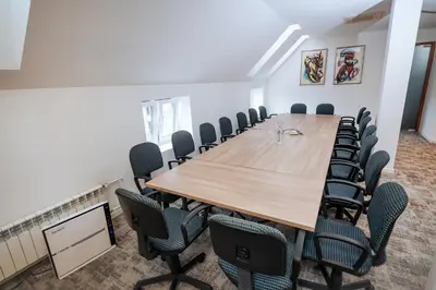 a conference room with a wooden table and chairs at Hotel Zepter Palace in Banja Luka