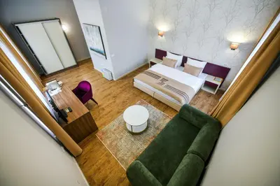 an overhead view of a bedroom with a bed and a couch at Hotel Zepter Palace in Banja Luka