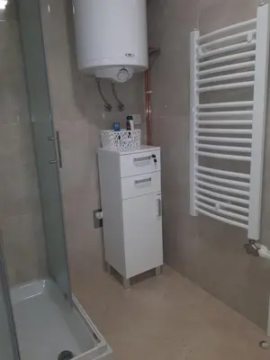 a small bathroom with a sink and a white appliance at Apartman KIWI in a quite central area in Banja Luka