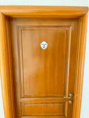 a wooden door with a sticker on it at Apartmani Ćurković in Kupres