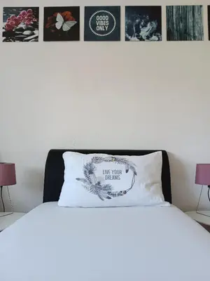 a bed with a white pillow on top of it at DreamHouse in Jajce