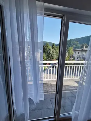 a view from a window with white curtains at DreamHouse in Jajce