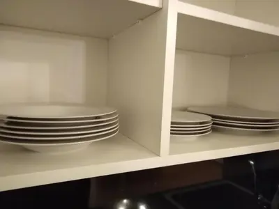 a kitchen with white plates and bowls on a shelf at DreamHouse in Jajce