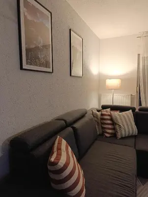 a living room with a brown couch with pillows at DreamHouse in Jajce