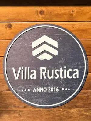 a sign that says villa rustica on a wooden wall at Villa Rustica in Šišava