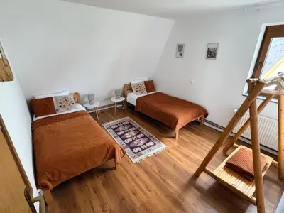 a bedroom with two beds and a staircase at Villa Rustica in Šišava