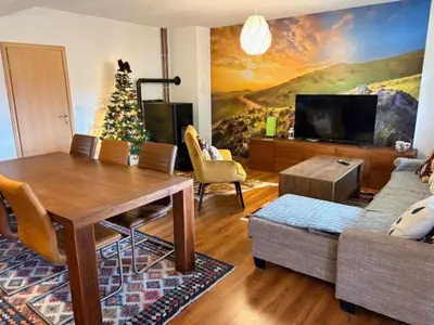 a living room with a table and a christmas tree at Villa Rustica in Šišava