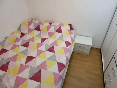 a couch in a room with a colorful at Stan na dan Prnjavor, Gajba u centru in Prnjavor