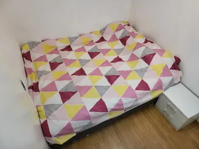 a bed in a corner of a room at Stan na dan Prnjavor, Gajba u centru in Prnjavor