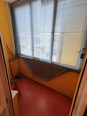 a room with a large window and a red tile floor at Stan na dan Prnjavor, Gajba u centru in Prnjavor