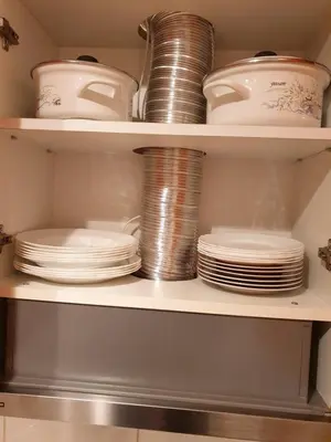 a shelf full of dishes and plates in a pantry at Stan na dan Prnjavor, Gajba u centru in Prnjavor