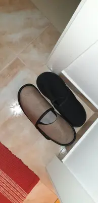 a pair of black shoes sitting on the floor at Stan na dan Prnjavor, Gajba u centru in Prnjavor