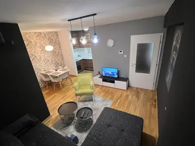 a living room with a couch and a dining room at CITY in Banja Luka