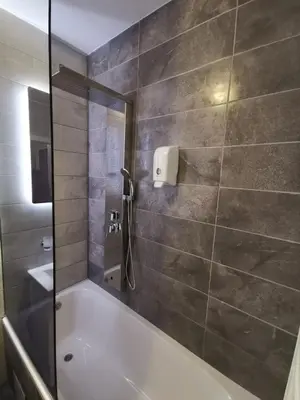 a bathroom with a bath tub and a shower at CITY in Banja Luka