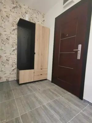 a room with a wooden door and a tiled floor at CITY in Banja Luka