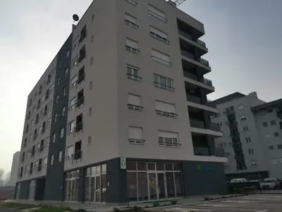 an apartment building in front of a parking lot at CITY in Banja Luka