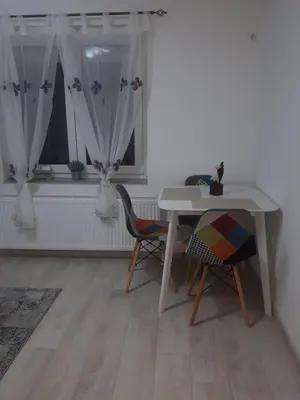 a table and chairs in a room with a window at Apartman Mango Banja Luka center hospital Free parking in Banja Luka