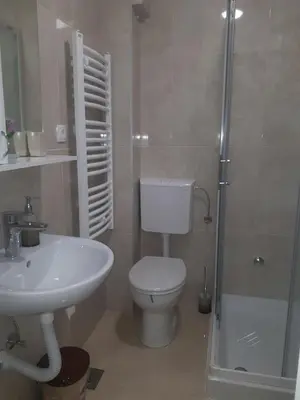 a bathroom with a toilet and a sink and a shower at Apartman Mango Banja Luka center hospital Free parking in Banja Luka
