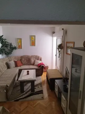 a living room with a couch and a tv at Apartman Luka in Kupres