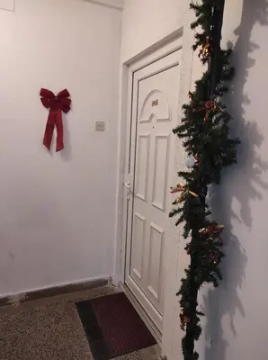 a door with a bow and a christmas ornament at Apartman Luka in Kupres