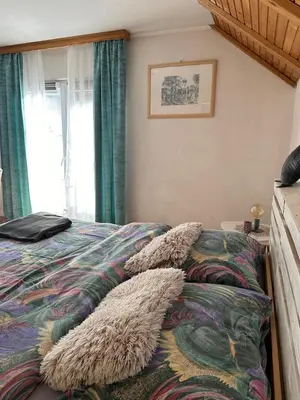 a bedroom with a bed with furry pillows on it at -Moon- in Kupres