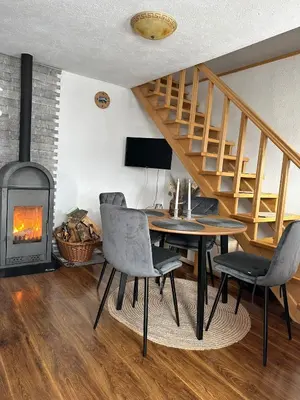a dining room with a table and a fire place at -Moon- in Kupres