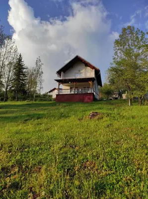 a house on top of a grassy field in front at Vlasic holiday home in Vlasic