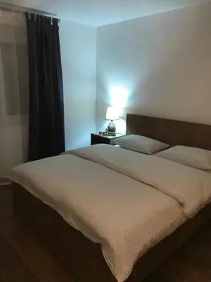 a bedroom with a bed and a lamp on a table at Sarah in Kupres