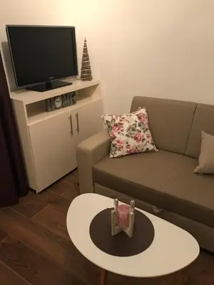 a living room with a couch and a tv at Sarah in Kupres