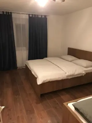 a bedroom with two beds and a wooden floor at Sarah in Kupres
