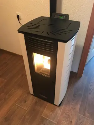 a black and white stove with a fire in it at Sarah in Kupres