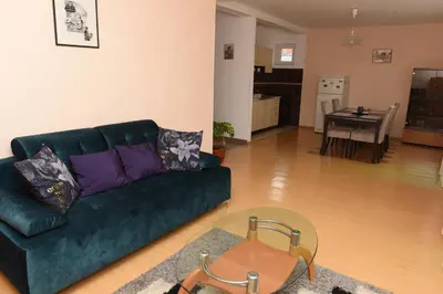 a living room with a green couch and a table at Bingo Apartments in Banja Luka