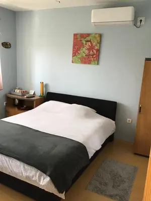 a bedroom with a bed with a black and white blanket at Bingo Apartments in Banja Luka