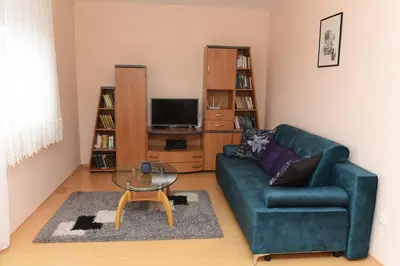 a living room with a green couch and a coffee table at Bingo Apartments in Banja Luka
