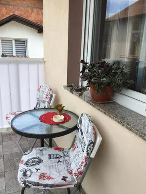 a table and two chairs sitting on a window sill at Bingo Apartments in Banja Luka