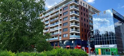 a tall brick building with a glass at Extra Apartman-City Center with Parking in Banja Luka