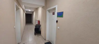 a hallway with a walkway with a luggage bag in it at Extra Apartman-City Center with Parking in Banja Luka
