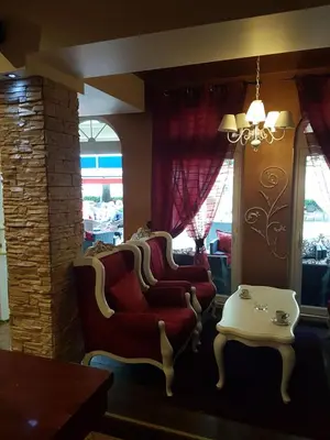 a living room with two chairs and a table at Prenociste Lane in Ključ