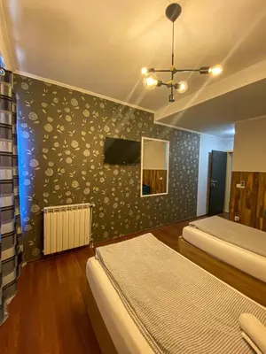 a bedroom with two beds and a wall with a mirror at Prenociste Lane in Ključ
