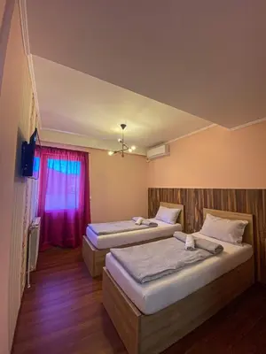 a room with two beds and a window at Prenociste Lane in Ključ