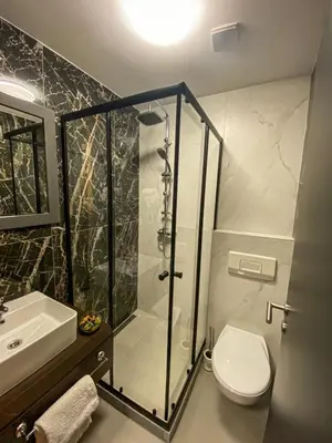a bathroom with a shower and a toilet and a sink at Prenociste Lane in Ključ