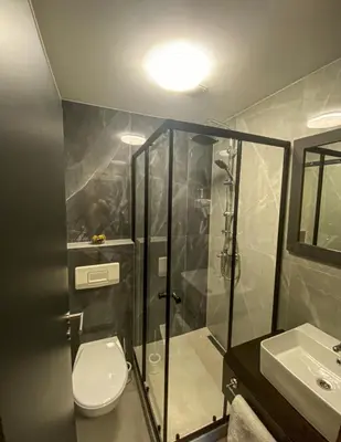 a bathroom with a shower and a toilet and a sink at Prenociste Lane in Ključ