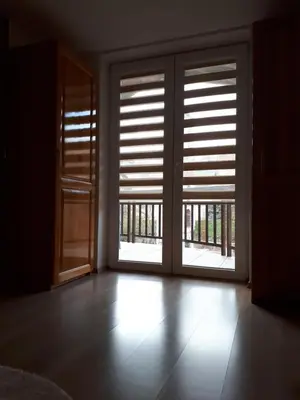 an empty room with an open door with blinds at Apartman Ivana in Jajce