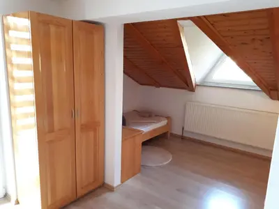 a room with a closet and a bed in a attic at Apartman Ivana in Jajce