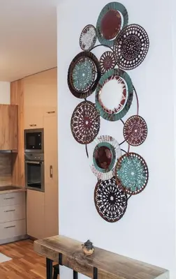 a group of plates hanging on a wall in a kitchen at Bright, modern & cozy apartment in Tuzla