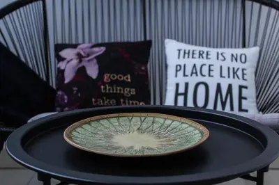 a black table with a plate on top of it at Bright, modern & cozy apartment in Tuzla