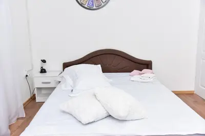 a white bed with white sheets and pillows at Apartmani Koko in Banja Luka